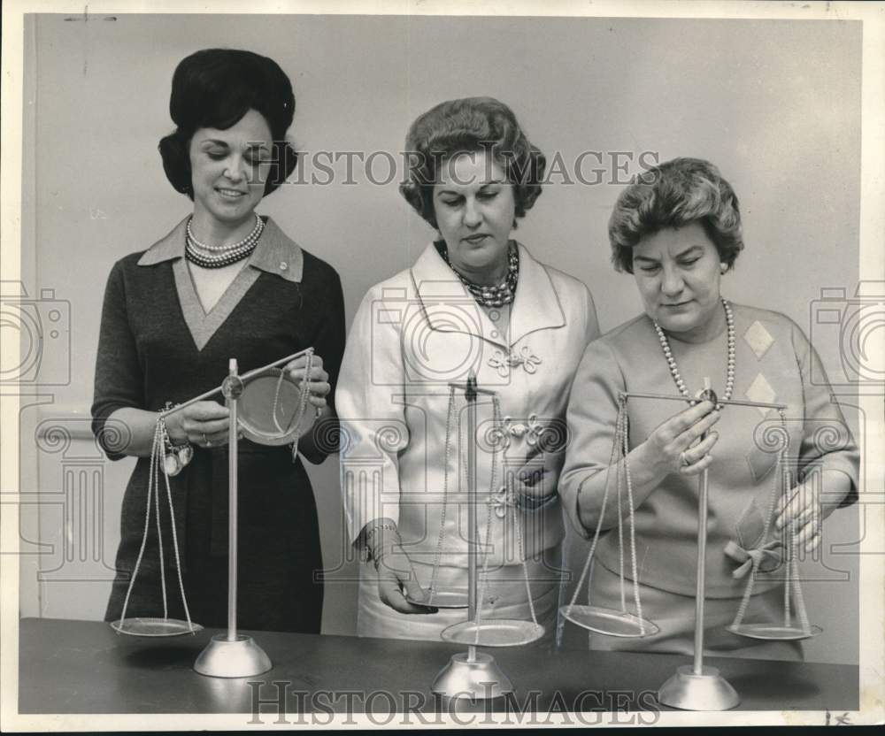 1966 Audrey Schenck with other women stand at "scales of justice." - Historic Images