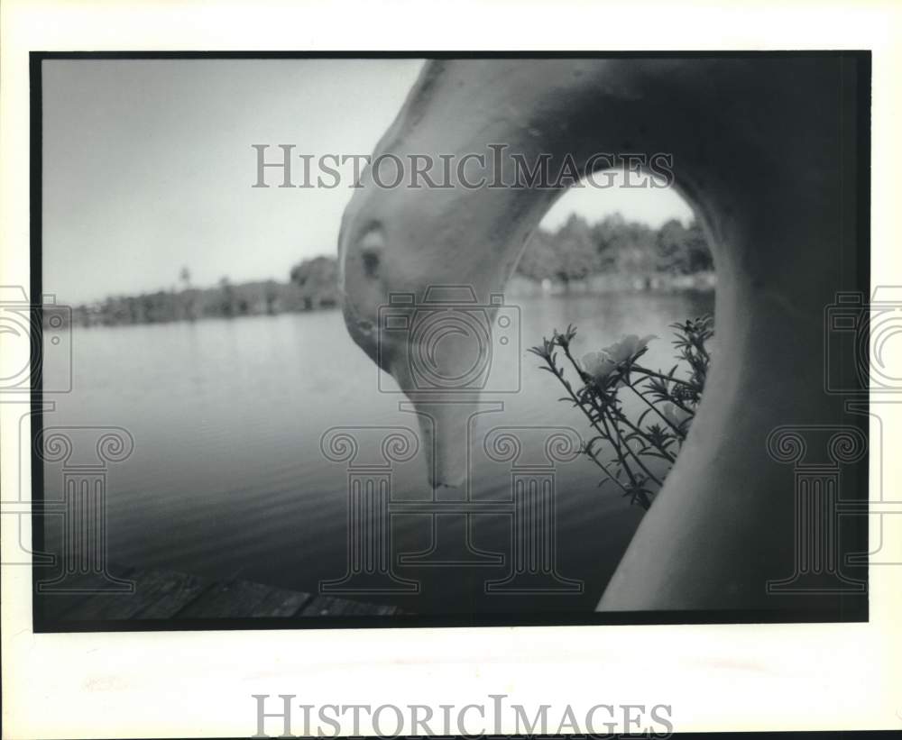 1992 Swan sculpture shown on a lake - Historic Images