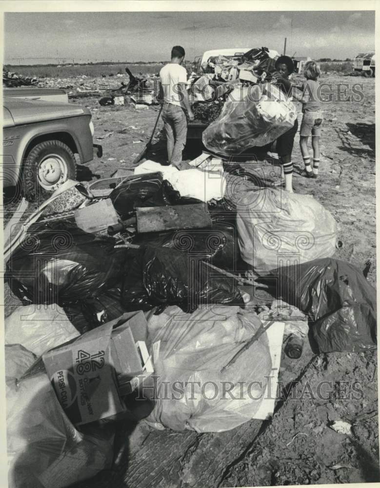 1978 Sanitation Department - Residents dump piles of garbage - Historic Images