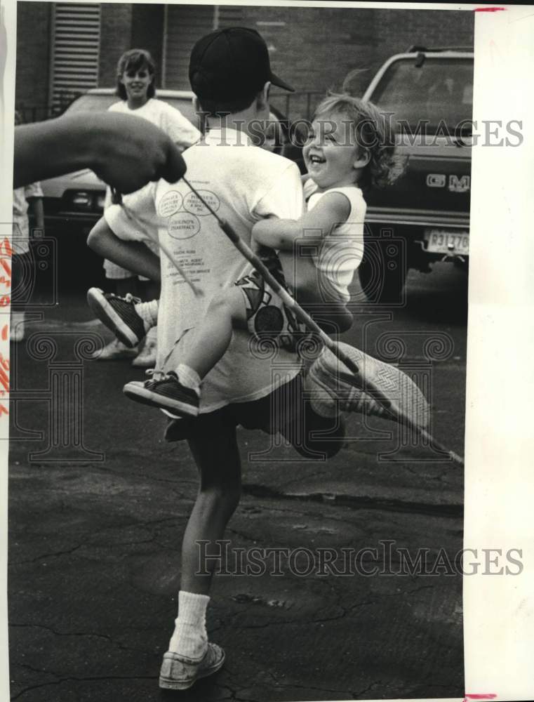 1987 St. Clement of Rome Summer Camp participants jump rope - Historic Images