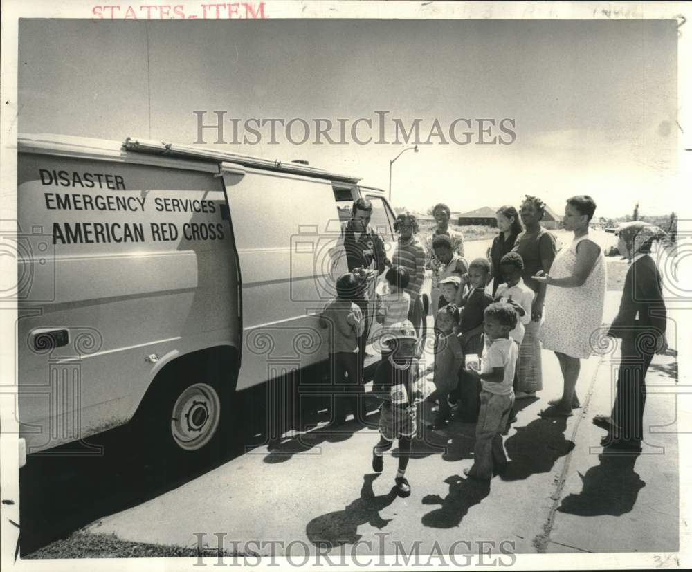 1978 Red Cross volunteer Lee Lauderdale delivers food to West Bank - Historic Images