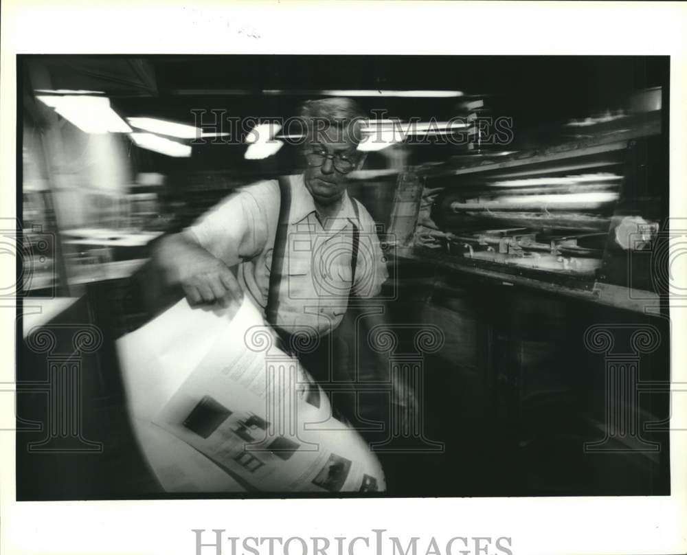 1995 Upton Printing pressman Robert Cook Sr. checks printing quality - Historic Images