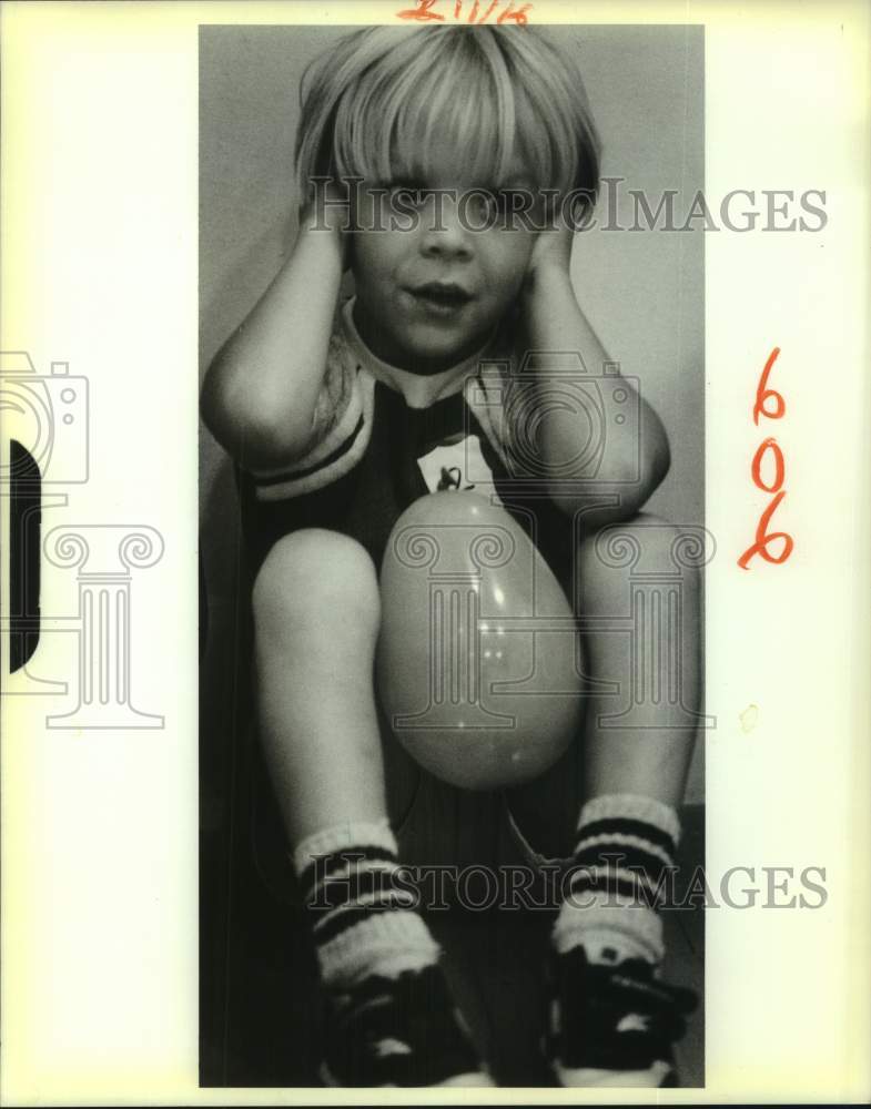 1988 Gregory Kathman covers ears at YMCA balloon relay, Kenner, LA - Historic Images