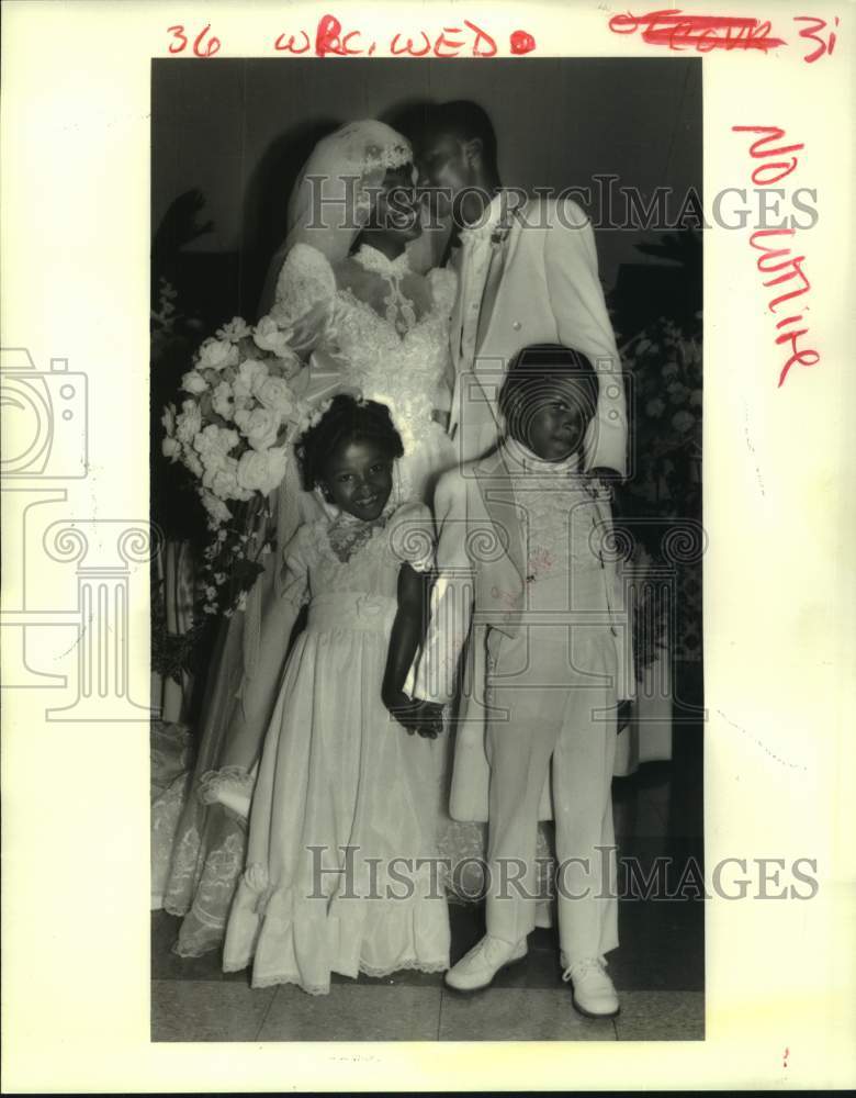 1985 Jeanette Magee &amp; John Riddle share kiss at their wedding - Historic Images