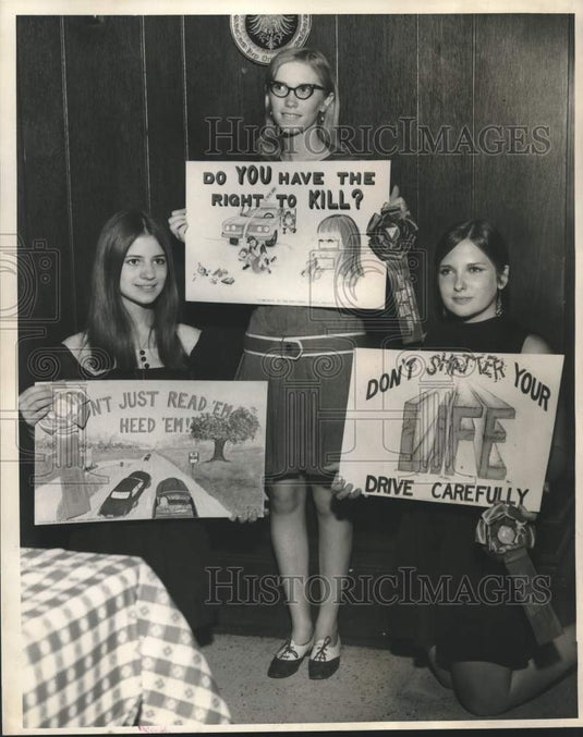 1968 Susan Sharp, Doris Wood & Adrian Deckbar hold safety posters - Historic Images