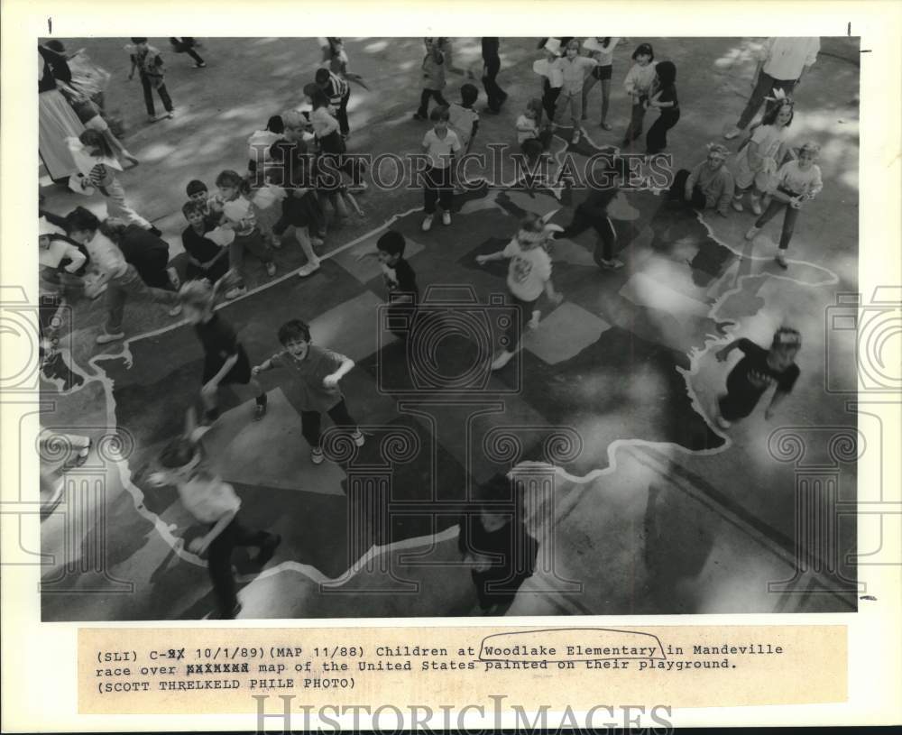 1989 Woodlake Elementary School children play on a map of the U.S. - Historic Images