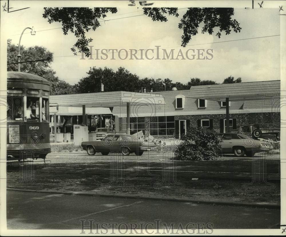 1972 St. Charles Avenue streetcar travels past new service station. - Historic Images