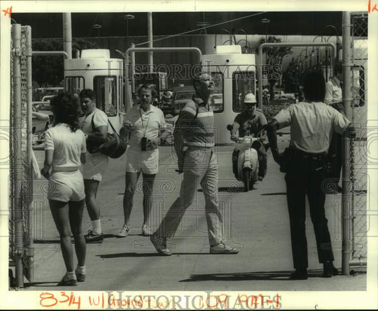 1984 Passers-byers at Louisiana World's Fair main gate. - Historic Images