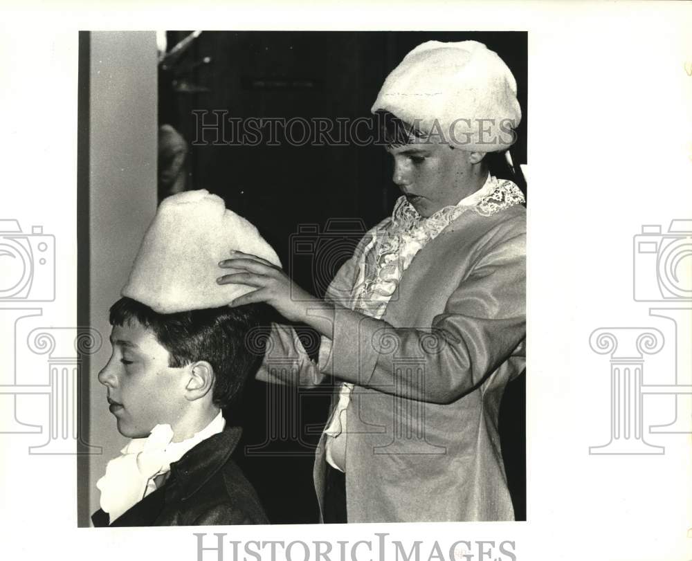 1987 St. Matthew School students adjust their wigs. - Historic Images