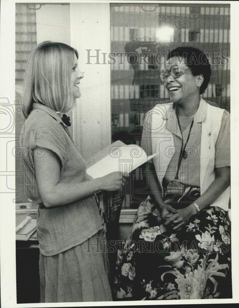 1978 Cheryl Q. Wilson and unidentified person looks over documents - Historic Images