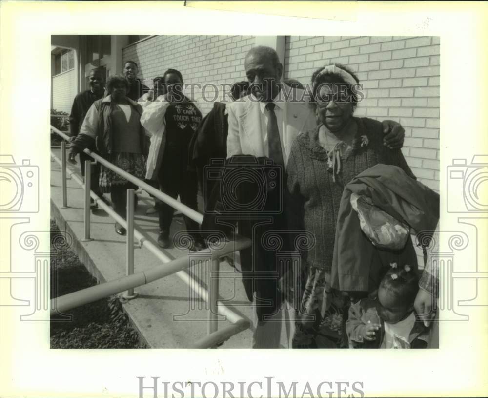 1992 Mabel Williams escorted by Reverend out of Parish Court House - Historic Images