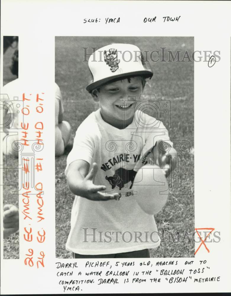 1984 Darryl Pichoff, 5, Catches Water Balloon at Metairie YMCA - Historic Images