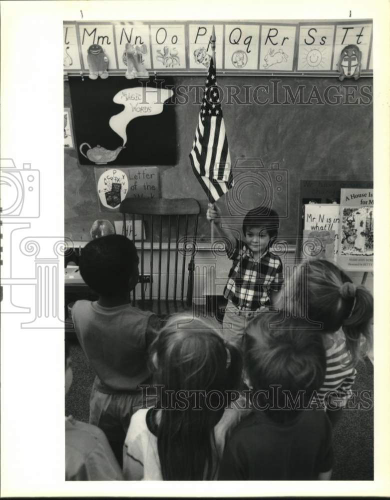 1989 Bradley Sison holds flag in Whispering Forest Elementary class - Historic Images