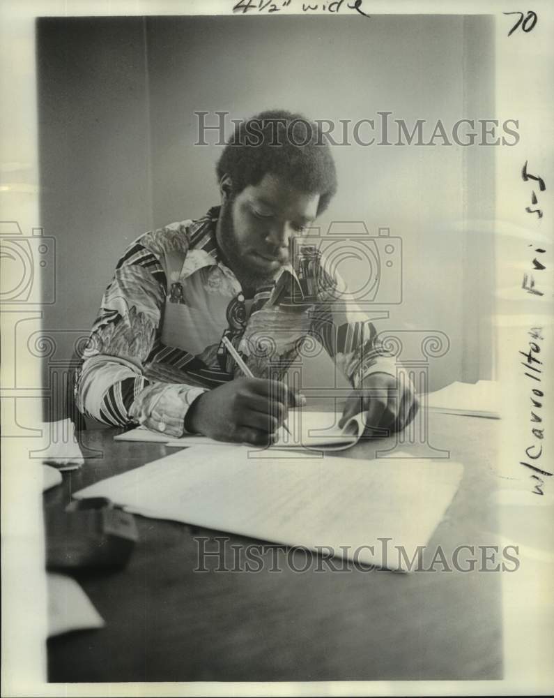 1976 Warren Webb, Carrollton Center director writes at Desk - Historic Images