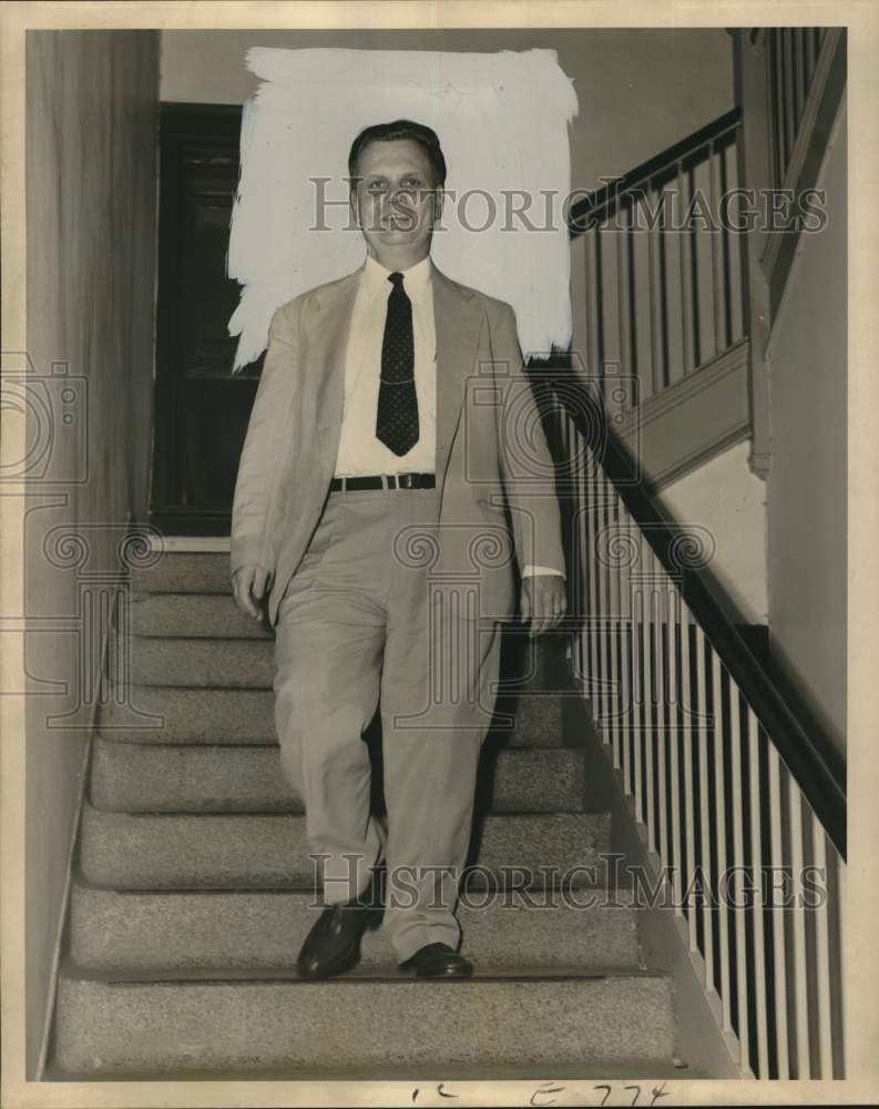 1952 William W. Shaw going down the stairs - Historic Images