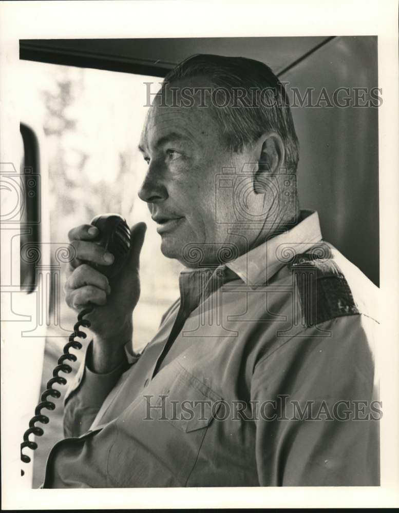 1974 Red Creek Wildlife manager Austin Shattles on his truck radio - Historic Images