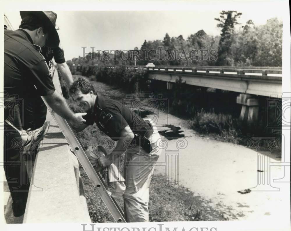 1990 Louisiana State Trooper Wayne Winkler helped by Albert Majeau - Historic Images