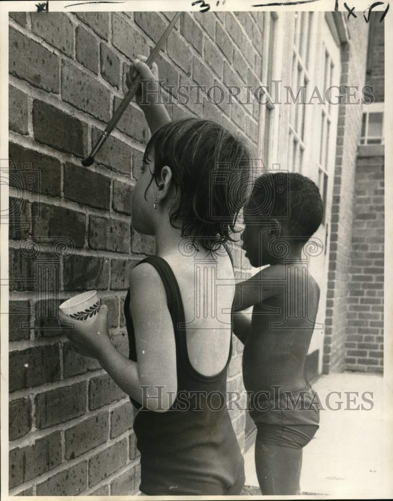 1970 Head Start children paint wall at Shaw School-Historic Images