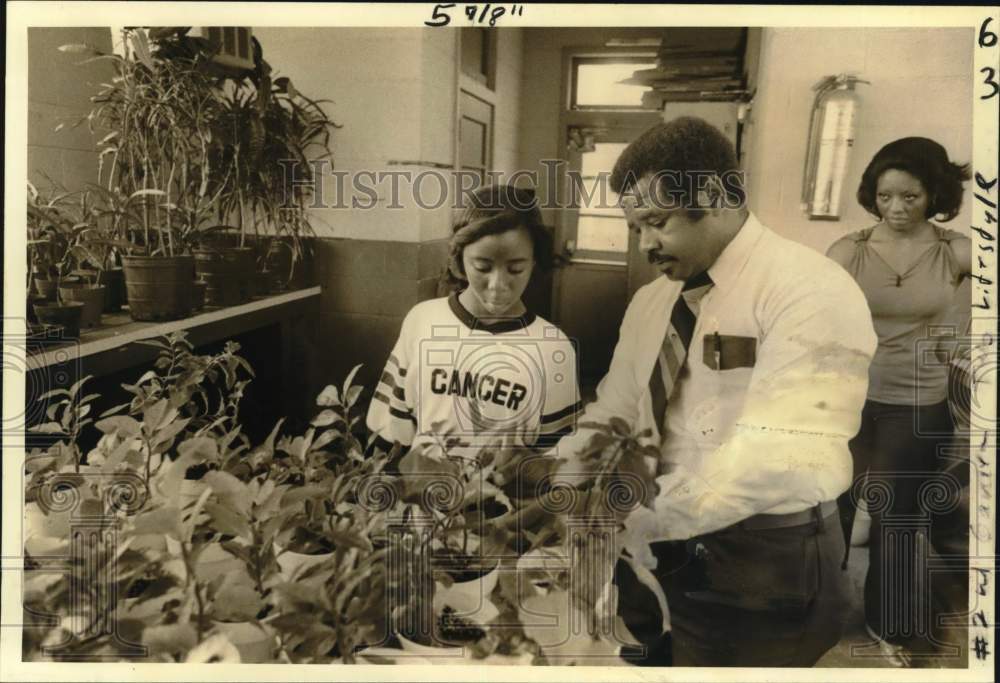 1981 Booker T. Washington teacher talks to student about plants - Historic Images