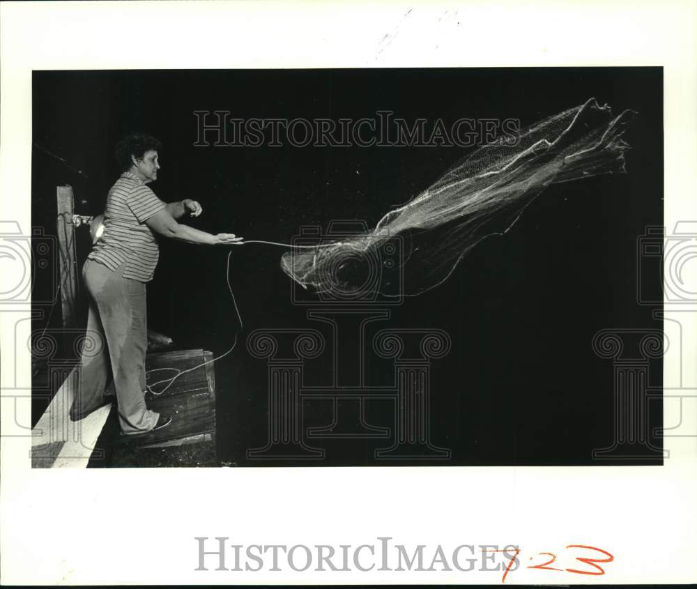 1987 Press Photo Mabel Nunez casting her net into Bayou Terre aux Boeufs- Historic Images