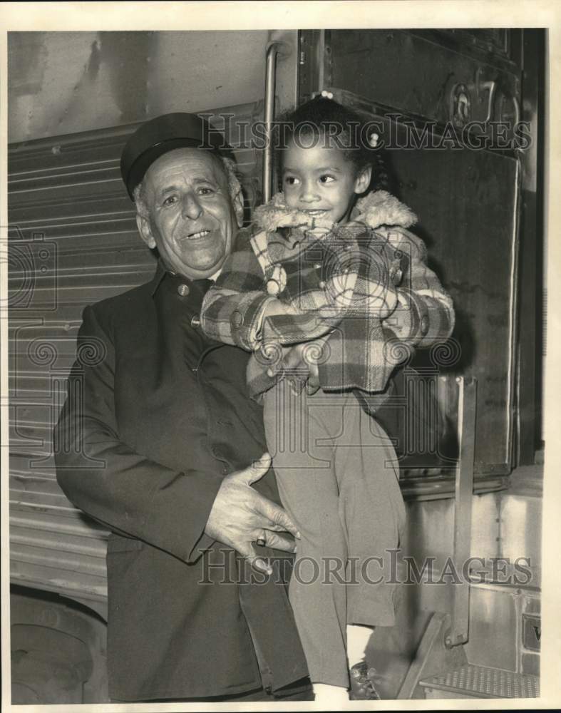 1971 Gordon A. Smith, retired Pullman porter, holding young friend - Historic Images