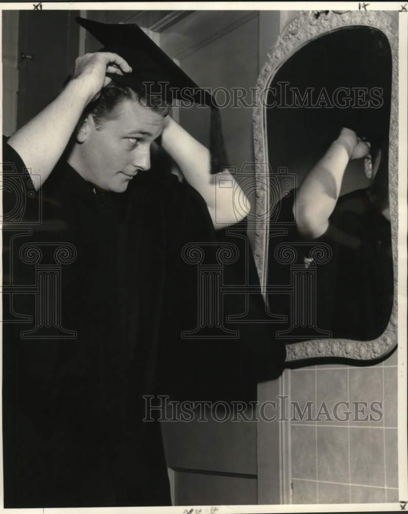 1959 Billy Stiles tries on cap &amp; gown before he goes to commencement - Historic Images