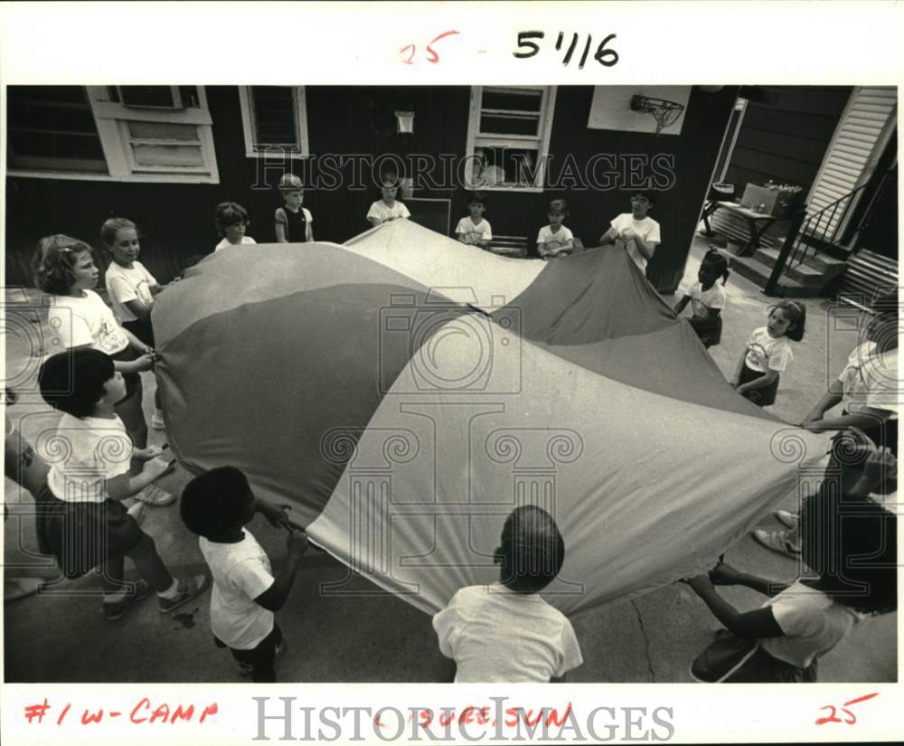 1985 Storybook Academy day campers use parachute - Historic Images