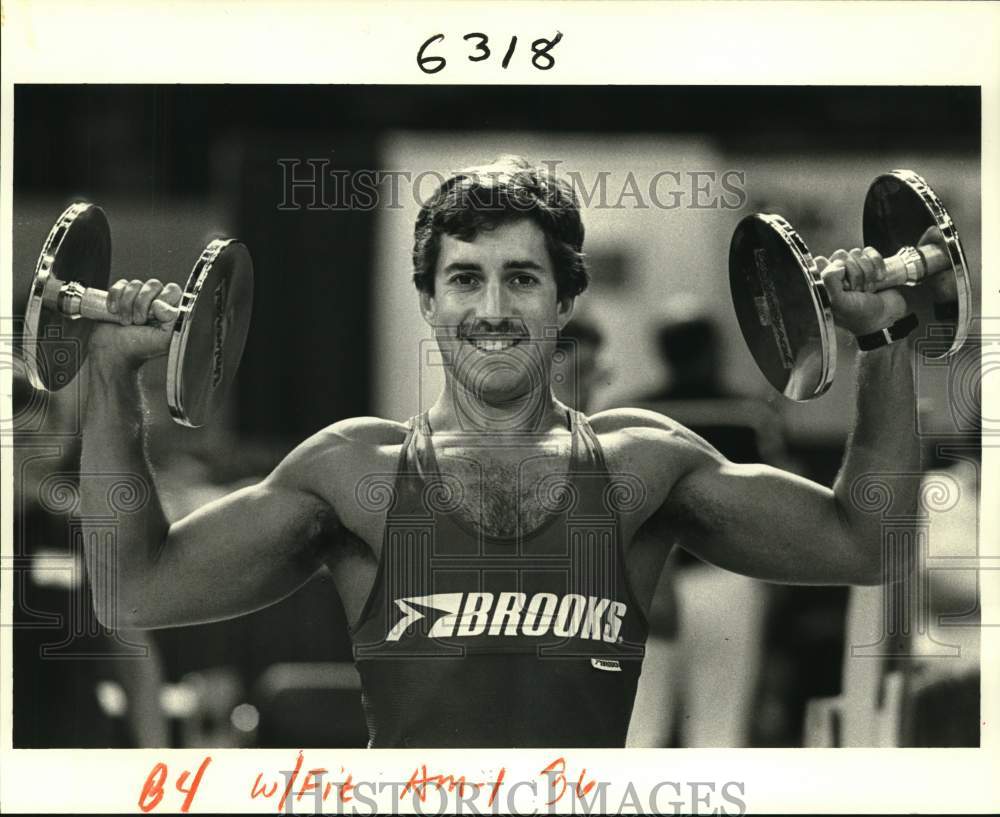 1984 Steve Sockol holds up dumbells - Historic Images