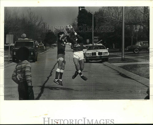 1983 Press Photo Soccer players pose with the ball at the street - noc67759- Historic Images