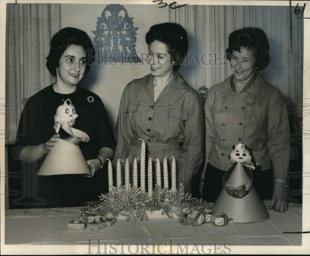 1965 Flower Fanciers Garden Club members with Chanukah arrangement - Historic Images