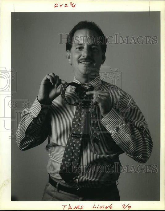 1989 Rick Vogler of Wimbley demonstrates how to tie a tie. - Historic Images