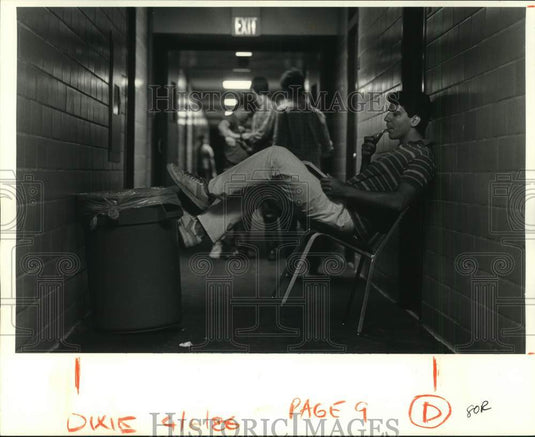 1986 Mike Grosse, dorm's resident assistant, relaxes with a book-Historic Images