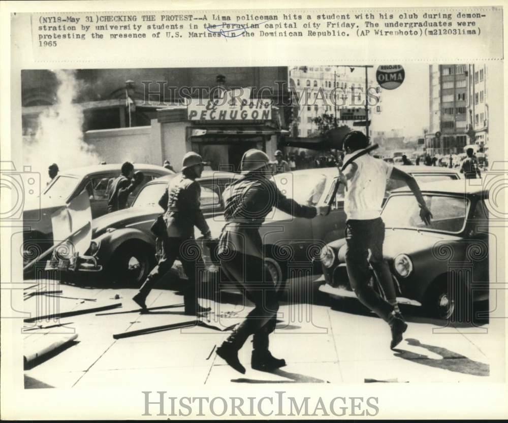 1965 A Lima police hits a student during demonstration in Lima, Peru-Historic Images