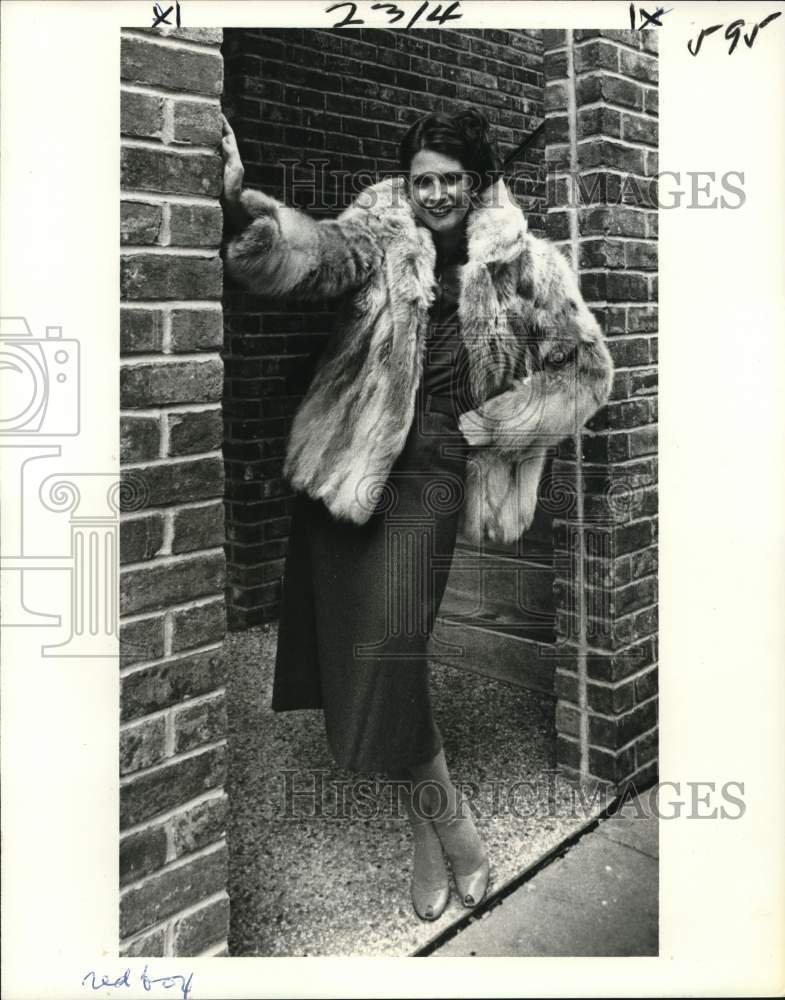 1979 A woman wears fox jacket over a matching blouse and skirt - Historic Images