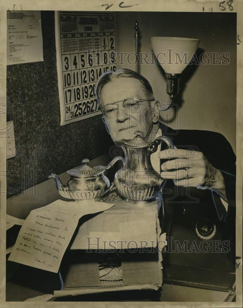 1960 Dave Hennessey views silver teapots at Sheraton-Charles Hotel - Historic Images