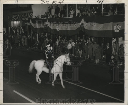 1960 New Orleans Mardi Gras officer salutes at Momus Parade Canal St - Historic Images