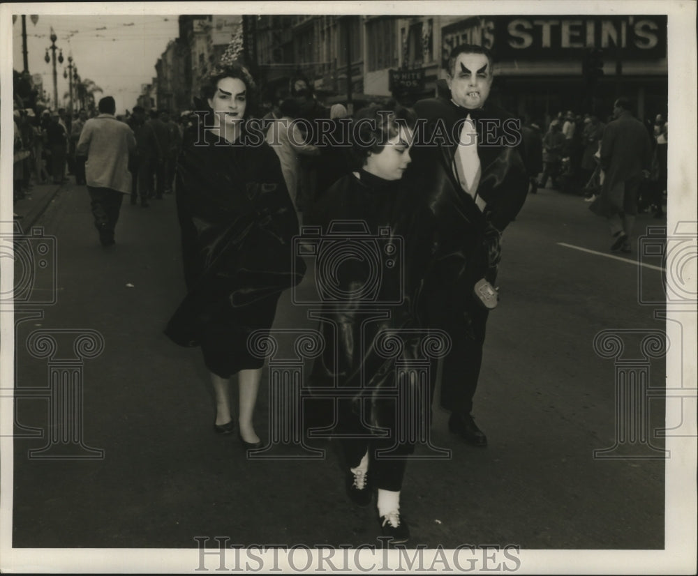 1960 New Orleans Mardi Gras revelers in the street  - Historic Images