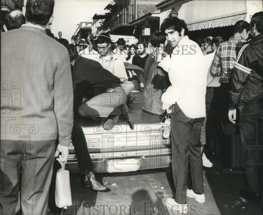 1970 people climb on cars during Mardi Gras Carnival  - Historic Images