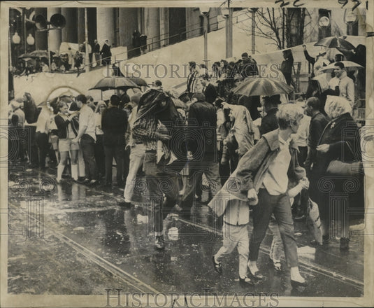 1967 Mardi Gras parade watchers get rained on  - Historic Images