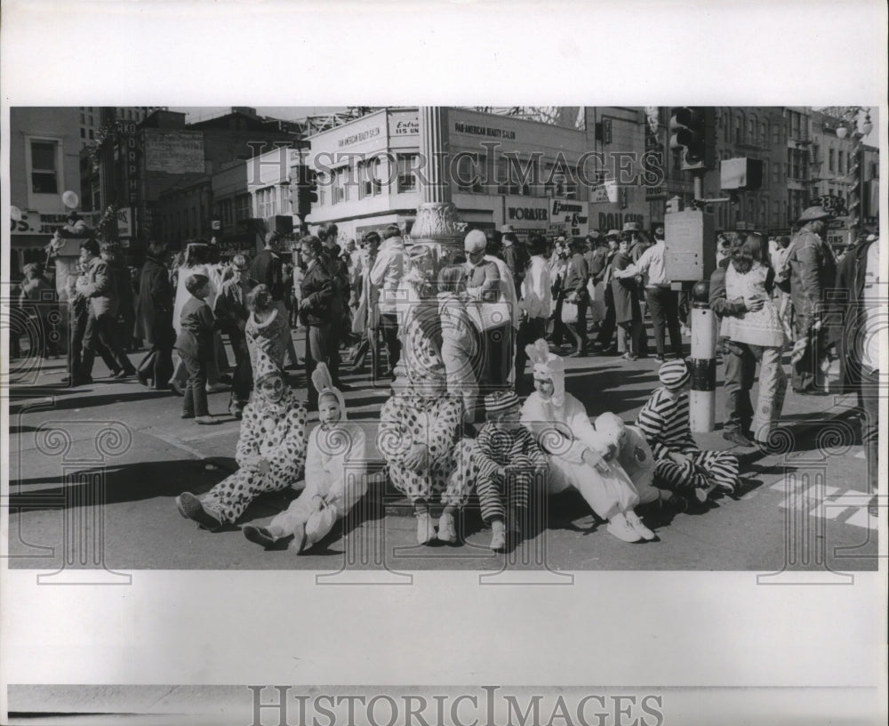 1971 maskers taking break on street during Mardi Gras  - Historic Images