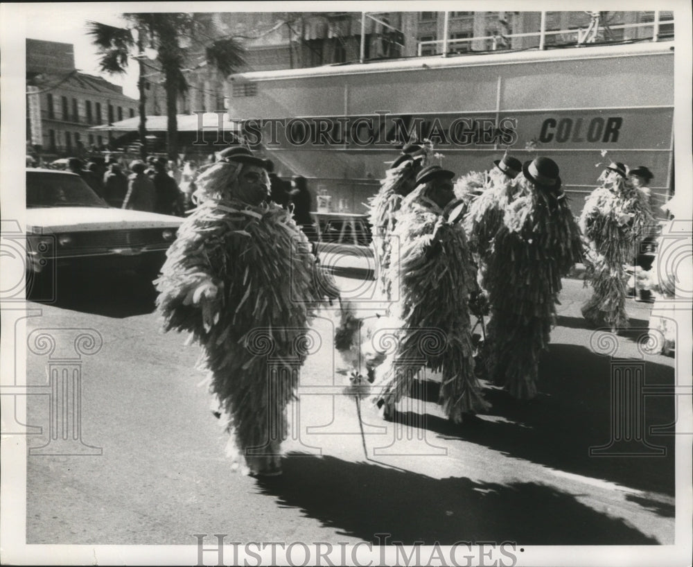 1971 men in furry costumes walk the street during Mardi Gras - Historic Images