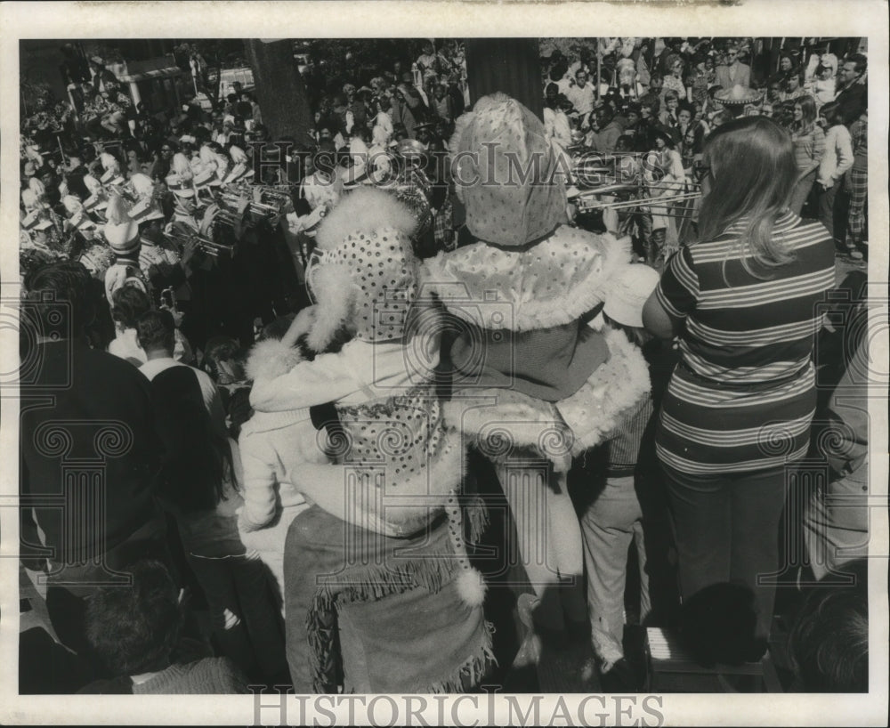 1971 Mardi Gras parade crowd watches passing marching band - Historic Images