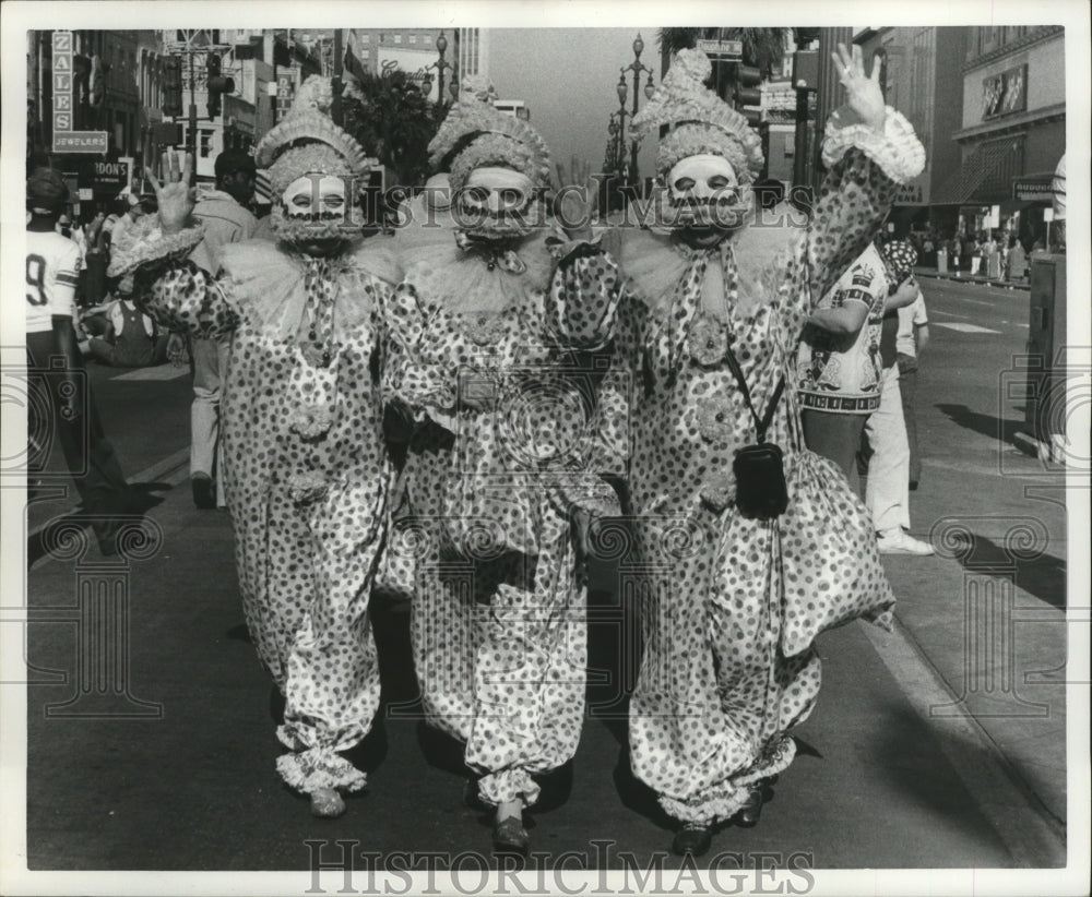 1977 Three Carnival Maskers March During Parade Mardi Gras, NO - Historic Images