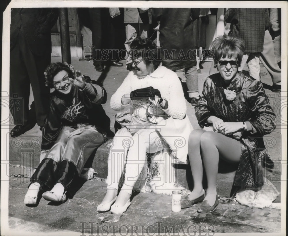 1964 Mardi Gras celebrators taking a break.  - Historic Images