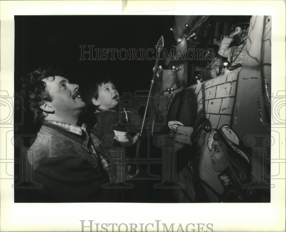 1990 Christopher Morris watches krewe of Gladiator Mardis Gras Float - Historic Images