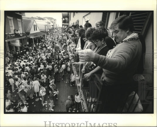 1990 balcony view of Bourbon street, crowd watching at Mardi Gras - Historic Images