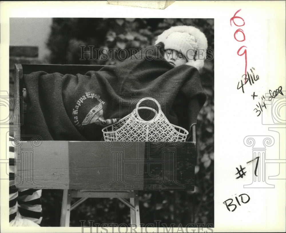 1989 Regan Norton sleeps during the Rex Parade at Uptown Mardi Gras - Historic Images