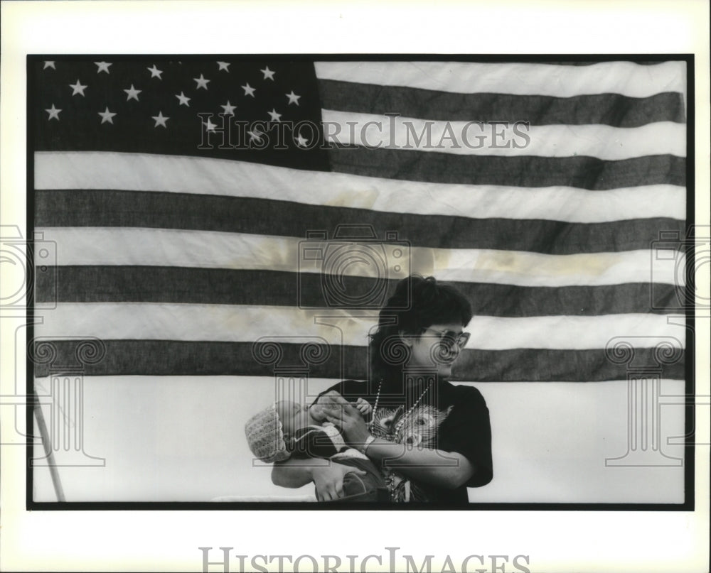 1991 Jane Guidry feeds her nephew at Mardi Gras - Historic Images