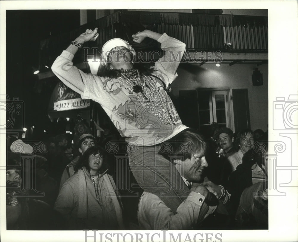 1986 Woman on Shoulders of Man at Mardi Gras Carnival in New Orleans - Historic Images