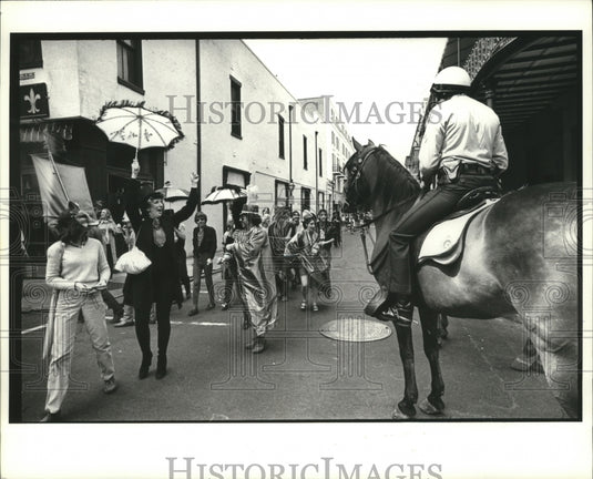 1980 Carnival Maskers Walks by Mounted Policeman in New Orleans - Historic Images
